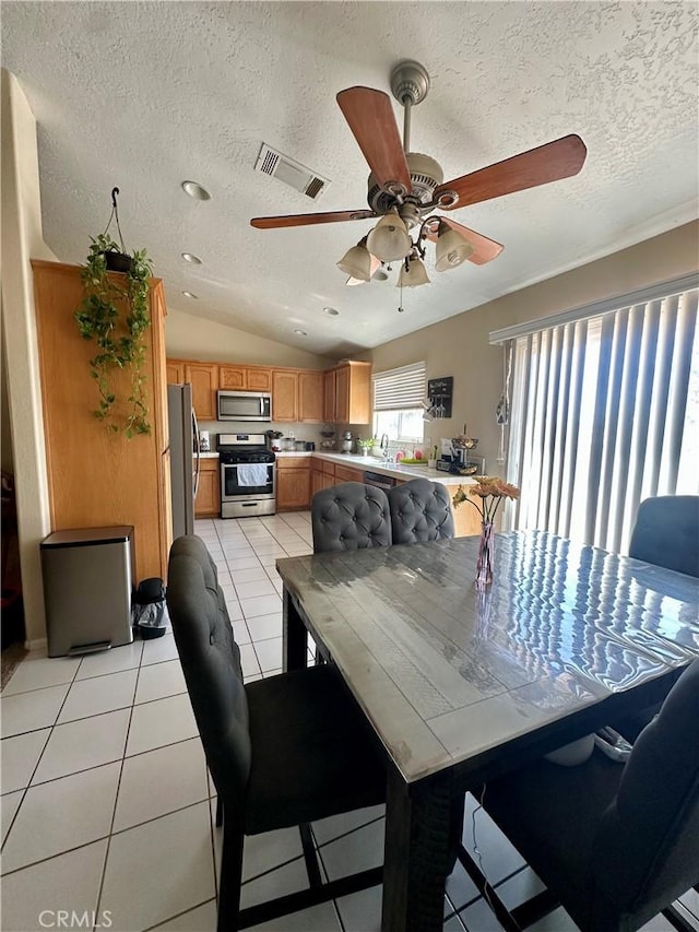 13133 4th Ave, Victorville, CA 92395 - dining room with a ceiling fan, a textured ceiling, lofted ceiling, and light tile patterned floors