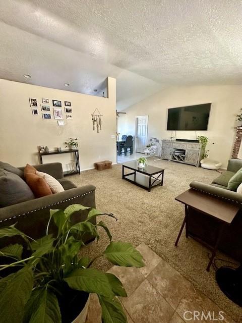 13133 4th Ave, Victorville, CA 92395 - carpeted living area featuring lofted ceiling and a textured ceiling