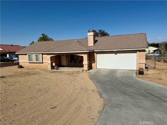 13133 4th Ave, Victorville, CA 92395 - ranch-style house featuring driveway, stucco siding, a chimney, and a garage