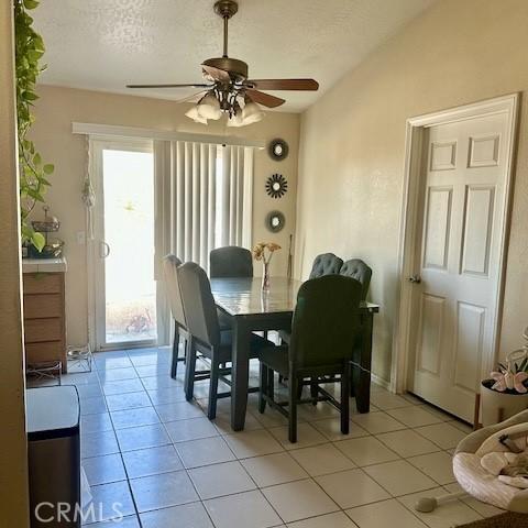 13133 4th Ave, Victorville, CA 92395 - dining area with a ceiling fan, light tile patterned floors, vaulted ceiling, and a textured ceiling