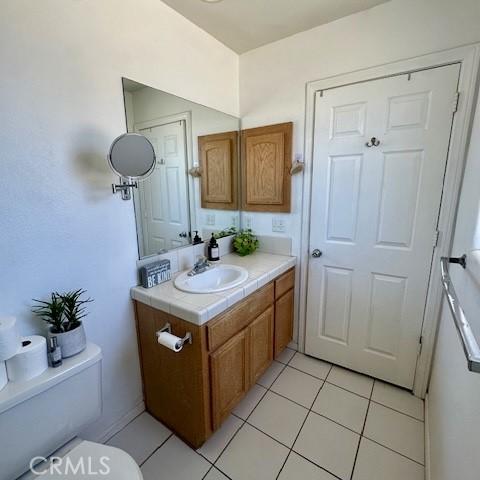 13133 4th Ave, Victorville, CA 92395 - half bath featuring vanity and tile patterned floors
