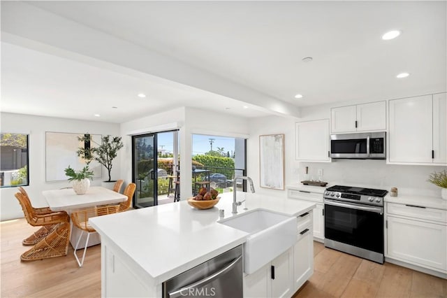 246 Fairview St, Laguna Beach, CA 92651 - kitchen featuring appliances with stainless steel finishes, light countertops, recessed lighting, light wood-style floors, and white cabinets