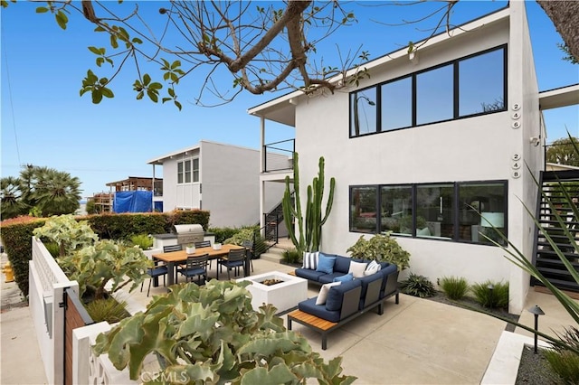 246 Fairview St, Laguna Beach, CA 92651 - view of patio featuring stairway, an outdoor living space with a fire pit, and outdoor dining space