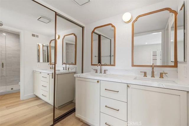 24616 Polaris Dr Unit 272, Dana Point, CA 92629 - full bathroom with double vanity, wood finished floors, and a shower stall