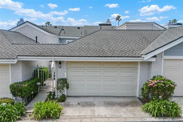 24616 Polaris Dr Unit 272, Dana Point, CA 92629 - view of front of house with a garage, stucco siding, and roof with shingles