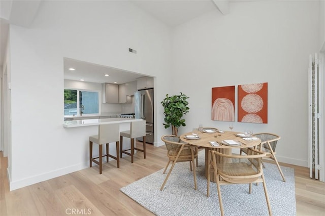 24616 Polaris Dr Unit 272, Dana Point, CA 92629 - dining room featuring light wood finished floors, high vaulted ceiling, and beamed ceiling