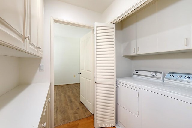 2600 Newport Blvd Unit 219, Newport Beach, CA 92663 - laundry room featuring washer and dryer, cabinet space, and light wood-type flooring