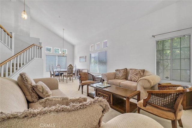 16737 Windcrest Dr, Fontana, CA 92337 - living area featuring high vaulted ceiling, carpet floors, stairway, and a chandelier