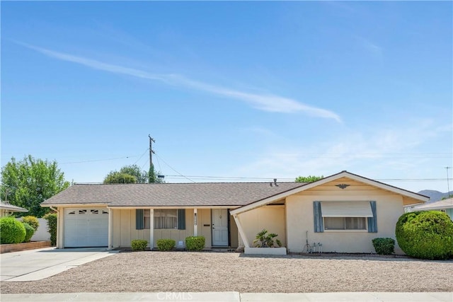 28839 Carmel Rd, Menifee, CA 92586 - ranch-style home featuring an attached garage, concrete driveway, board and batten siding, and roof with shingles