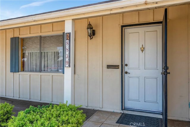 28839 Carmel Rd, Menifee, CA 92586 - doorway to property featuring board and batten siding