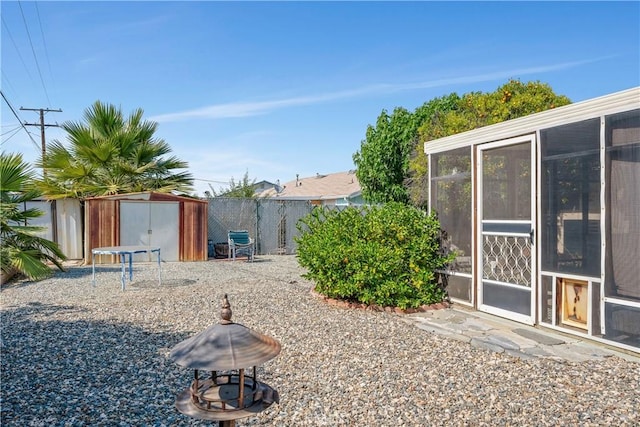 28839 Carmel Rd, Menifee, CA 92586 - fenced backyard with a storage unit and a sunroom
