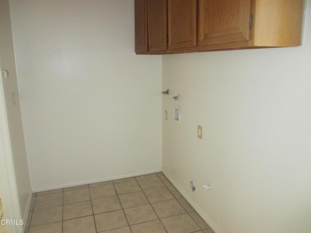 44244 Carolside Ave, Lancaster, CA 93535 - laundry room with cabinet space, hookup for a washing machine, and light tile patterned floors