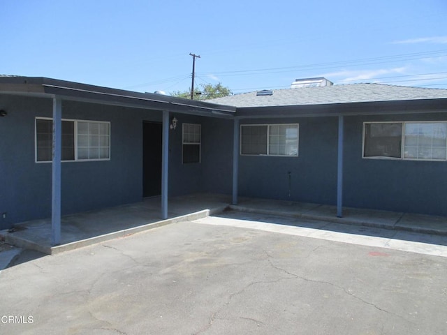 44244 Carolside Ave, Lancaster, CA 93535 - rear view of property with stucco siding and a shingled roof