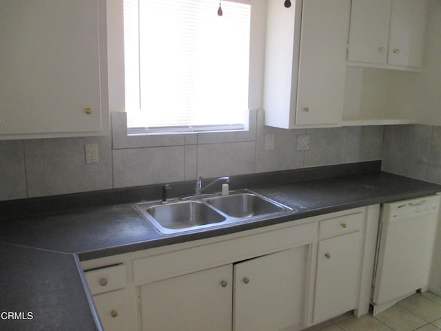 44244 Carolside Ave, Lancaster, CA 93535 - kitchen with white dishwasher, white cabinetry, dark countertops, and healthy amount of natural light
