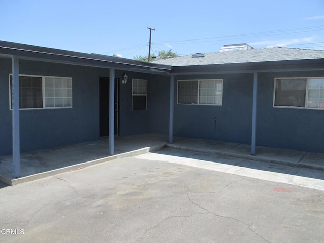 44244 Carolside Ave, Lancaster, CA 93535 - rear view of house with stucco siding and a shingled roof