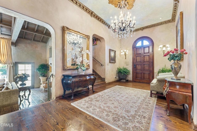 1205 Linda Vista Ave, Pasadena, CA 91103 - foyer featuring arched walkways, healthy amount of natural light, a chandelier, beamed ceiling, and ornamental molding