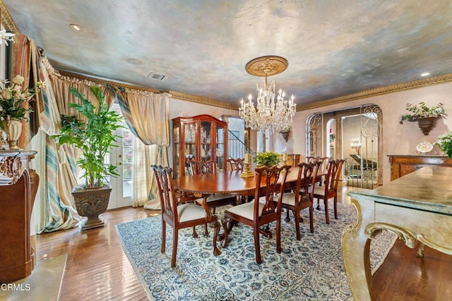 1205 Linda Vista Ave, Pasadena, CA 91103 - dining area with wood finished floors, arched walkways, a chandelier, and crown molding