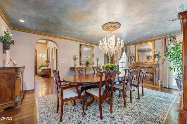 1205 Linda Vista Ave, Pasadena, CA 91103 - dining space featuring arched walkways, wood finished floors, a chandelier, and crown molding