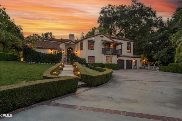 1205 Linda Vista Ave, Pasadena, CA 91103 - mediterranean / spanish house featuring a balcony, a chimney, stucco siding, an attached garage, and concrete driveway