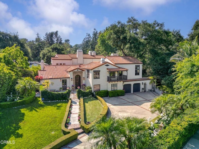 1205 Linda Vista Ave, Pasadena, CA 91103 - mediterranean / spanish-style house featuring stucco siding, a chimney, a tile roof, concrete driveway, and a front lawn