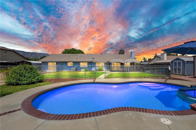 32618 Durango Ct, Wildomar, CA 92595 - pool at dusk with a storage unit, a pool with connected hot tub, and a fenced backyard