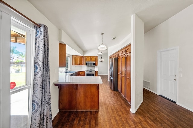 32618 Durango Ct, Wildomar, CA 92595 - kitchen with appliances with stainless steel finishes, a peninsula, brown cabinetry, dark wood-type flooring, and light countertops