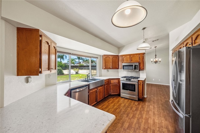 32618 Durango Ct, Wildomar, CA 92595 - kitchen featuring stainless steel appliances, a chandelier, light countertops, lofted ceiling, and brown cabinets