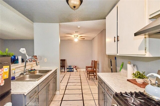 11131 Dodson St Unit 7, El Monte, CA 91733 - kitchen with range, light countertops, gray cabinetry, under cabinet range hood, and ceiling fan