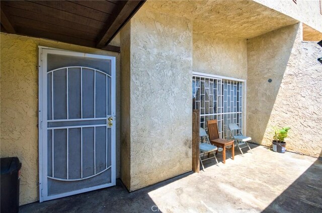 11131 Dodson St Unit 7, El Monte, CA 91733 - doorway to property with stucco siding and a patio area
