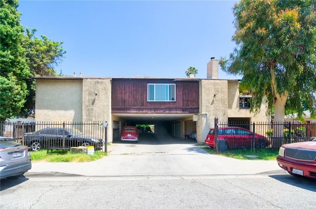 11131 Dodson St Unit 7, El Monte, CA 91733 - view of front of home with a chimney, a carport, and concrete driveway