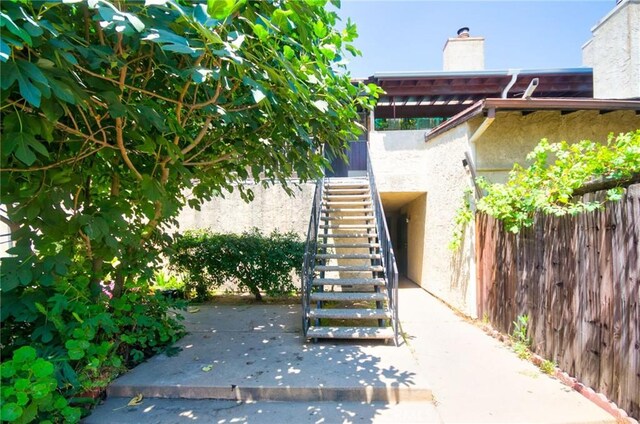 11131 Dodson St Unit 7, El Monte, CA 91733 - entrance to property featuring a chimney, stucco siding, and a patio