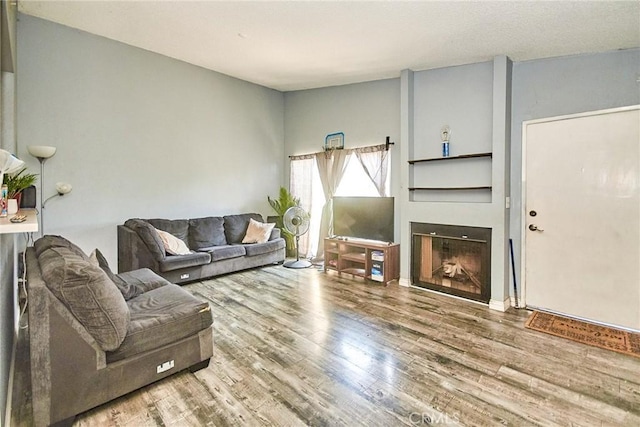 11131 Dodson St Unit 7, El Monte, CA 91733 - living room with wood finished floors and a fireplace