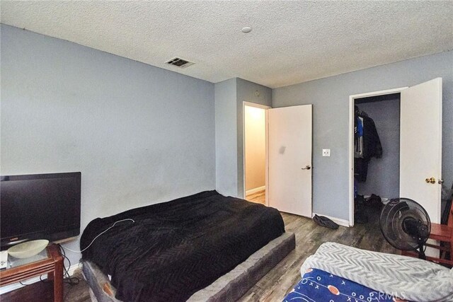 11131 Dodson St Unit 7, El Monte, CA 91733 - bedroom with wood finished floors and a textured ceiling