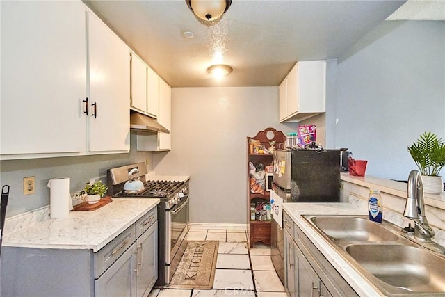 11131 Dodson St Unit 7, El Monte, CA 91733 - kitchen with stainless steel gas range, under cabinet range hood, gray cabinets, light countertops, and white cabinets