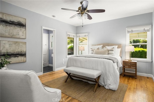2412 Santiago St, Santa Ana, CA 92706 - bedroom with multiple windows, light wood-style flooring, ensuite bath, and a ceiling fan