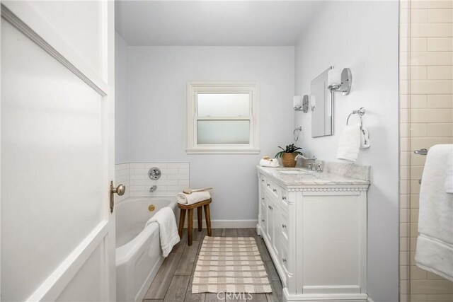 2412 Santiago St, Santa Ana, CA 92706 - bathroom featuring vanity, a bath, and wood finished floors