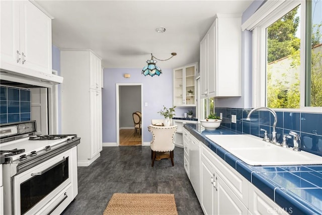 2412 Santiago St, Santa Ana, CA 92706 - kitchen with white gas range, exhaust hood, healthy amount of natural light, and white cabinetry