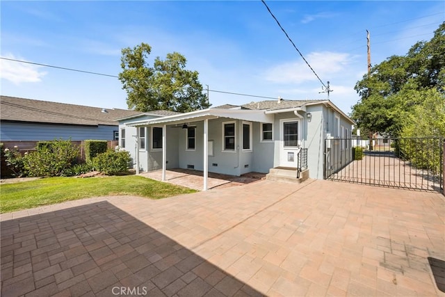 2412 Santiago St, Santa Ana, CA 92706 - back of house with stucco siding, a gate, and crawl space