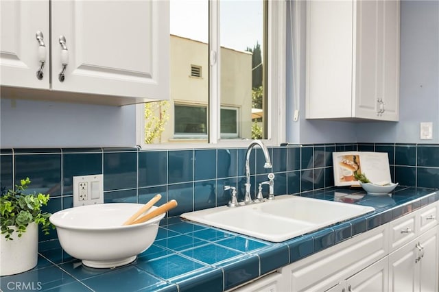 2412 Santiago St, Santa Ana, CA 92706 - kitchen featuring white cabinets, healthy amount of natural light, decorative backsplash, tile counters, and tile walls