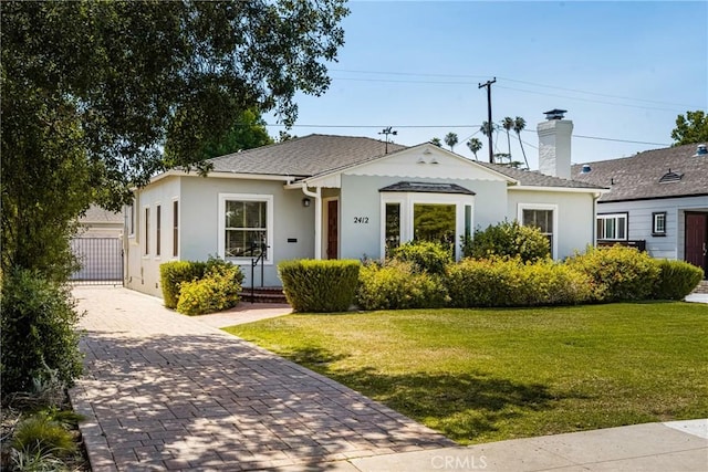 2412 Santiago St, Santa Ana, CA 92706 - view of front of property featuring stucco siding, a front yard, a chimney, and decorative driveway