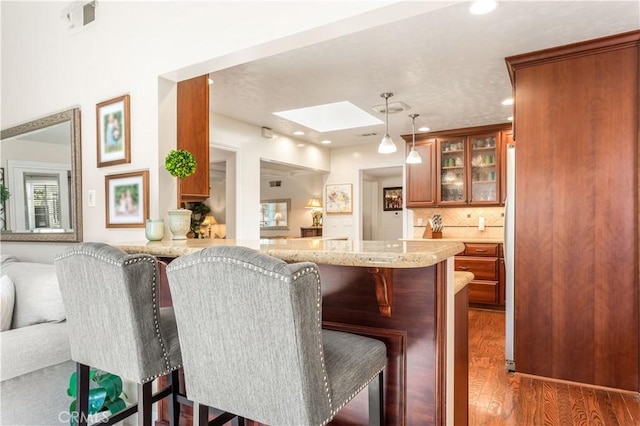 3191 Woodstock Rd, Rossmoor, CA 90720 - dining room featuring a skylight, wood finished floors, and recessed lighting