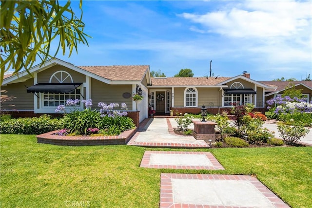 3191 Woodstock Rd, Rossmoor, CA 90720 - ranch-style house featuring a front yard, brick siding, and roof with shingles