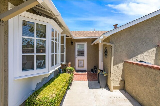 3191 Woodstock Rd, Rossmoor, CA 90720 - entrance to property featuring stucco siding and a shingled roof