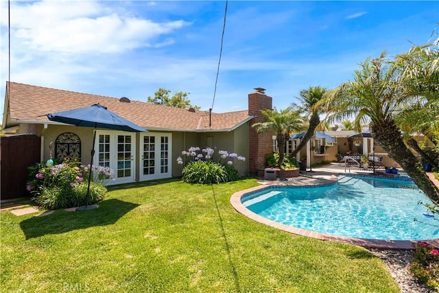 3191 Woodstock Rd, Rossmoor, CA 90720 - back of house featuring french doors, a chimney, an outdoor pool, stucco siding, and a patio