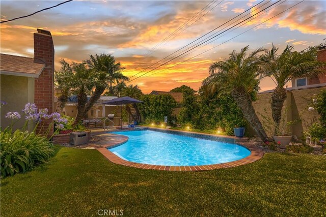 3191 Woodstock Rd, Rossmoor, CA 90720 - pool at dusk featuring a yard and an outdoor pool