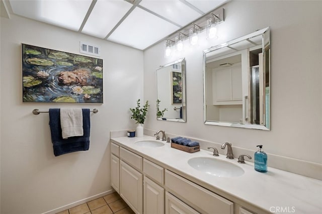 5520 Via La Mesa Unit A, Laguna Woods, CA 92637 - bathroom with double vanity, tile patterned flooring, and a shower with door