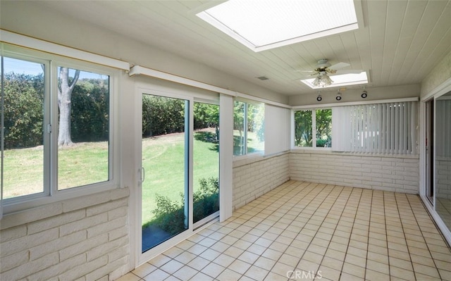5520 Via La Mesa Unit A, Laguna Woods, CA 92637 - unfurnished sunroom featuring a skylight, brick wall, ceiling fan, and tile patterned floors