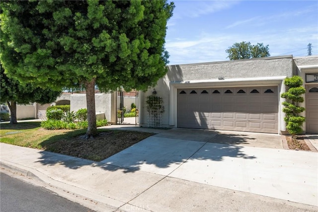 5520 Via La Mesa Unit A, Laguna Woods, CA 92637 - view of front facade featuring stucco siding, an attached garage, and driveway