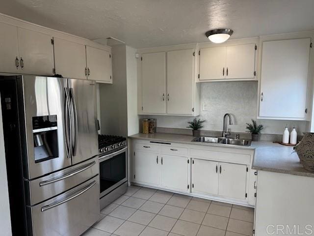 4454 Ute Dr, San Diego, CA 92117 - kitchen featuring stainless steel appliances, white cabinets, light tile patterned flooring, and light countertops