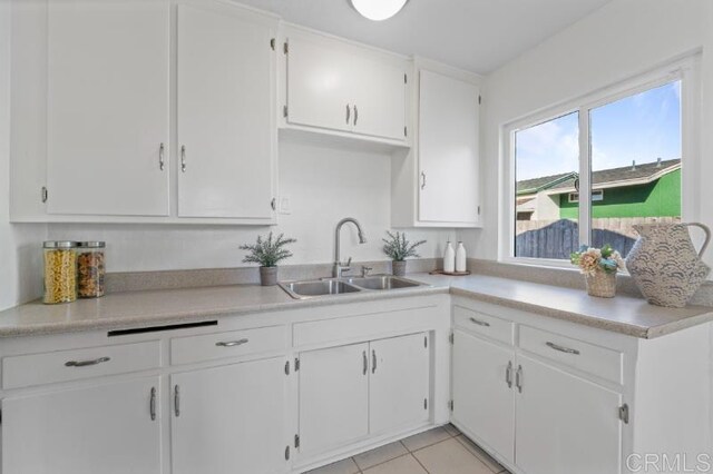 4454 Ute Dr, San Diego, CA 92117 - kitchen featuring white cabinets, light countertops, and light tile patterned floors